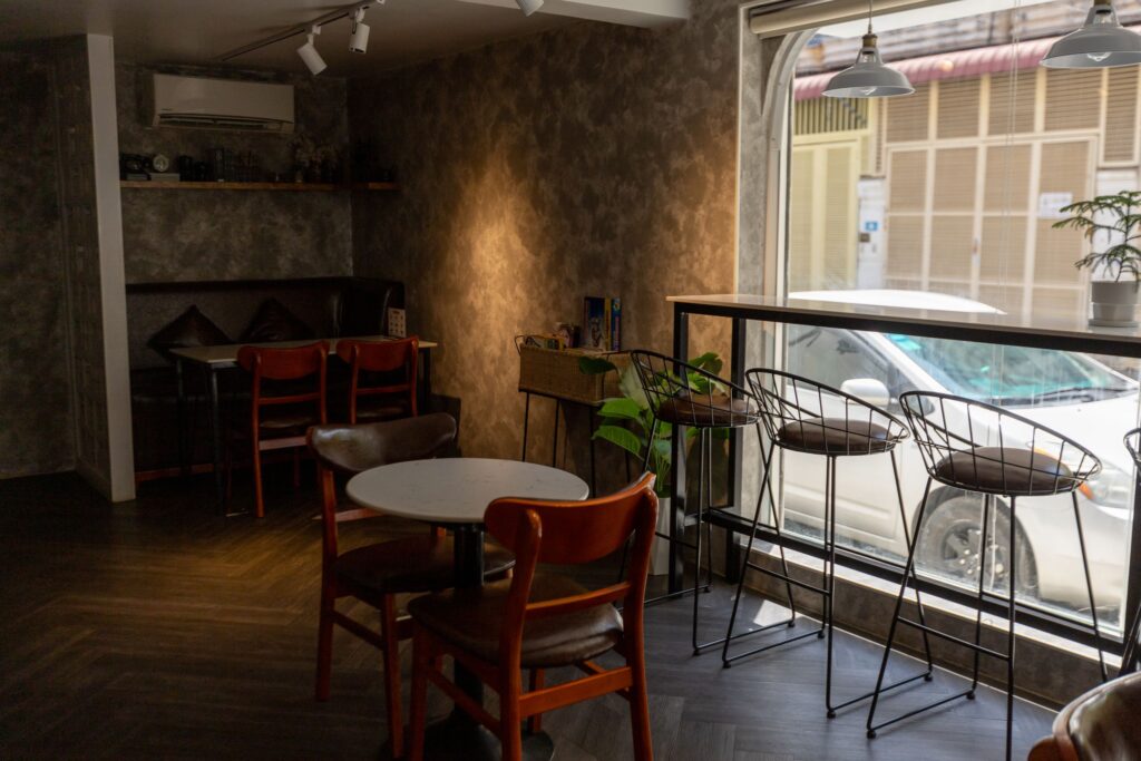 Inviting café interior with modern decor, natural light, and comfortable seating.