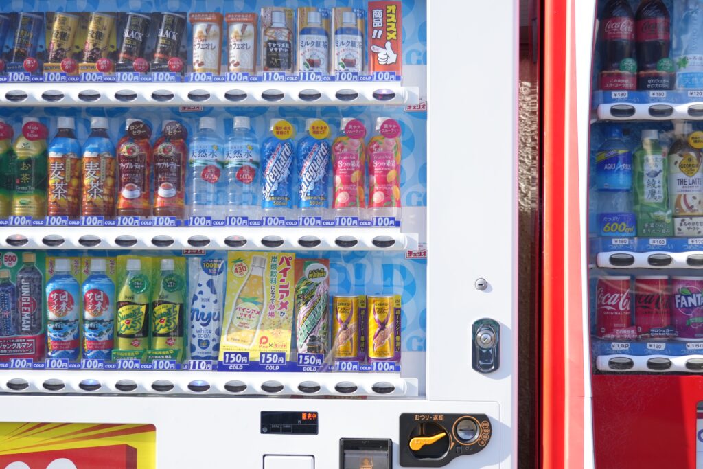 Vibrant vending machine in Kyoto showcasing diverse drink options. Captivating urban culture.